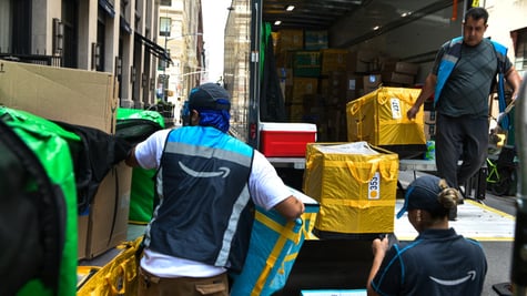 amazon prime logo, yellow plastic bags on brows cardboard boxes, two men, truck with open back