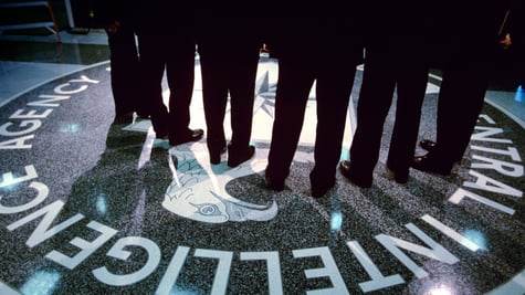 Footsteps and shadows on the CIA logo.