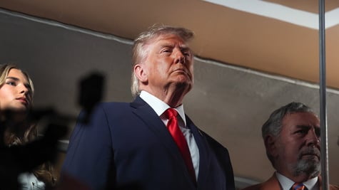 donald trump, black coat, white collar shirt, bright red tie, chin up, ivanka trump head in the left