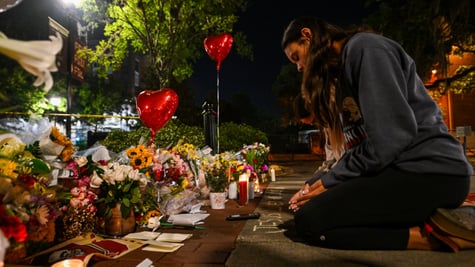 flowers, red heart balloons, woman on her knees praying on street, dark evening, long black hair