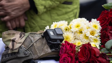 black gopro camera, white flowers, red roses, dark green and brown army uniform