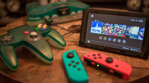 nintendo witch released in 2017, small black screen with video game on, sea blue and orange 