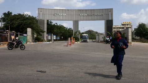 tata electronics cement gate, entrance, indian woman, blue sky, white clouds,