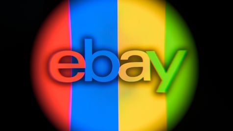 ebay logo in round shape that's in red, blue, yellow, green stripes, black background
