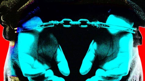 A person handcuffed behind their back