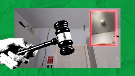 A hand holding a gavel, an AI-generated smoke detector in the corner of the room