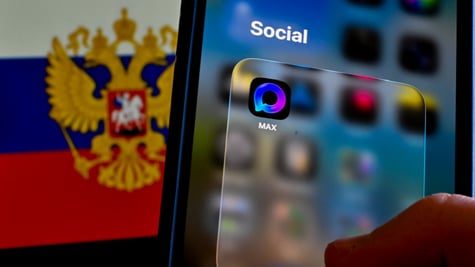 max app  icon on a smartphone, russia flag with eagles, coat of arms, in the background