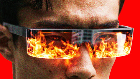 A person wearing smart glasses with flames reflecting on the lenses