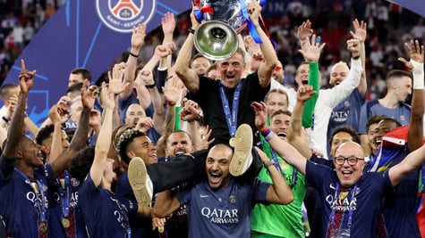 Luis Enrique sits on man's shoulder, men wearing  paris saint-germain club shirts, hands up