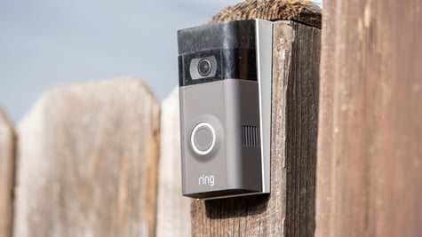 a Ring security camera fixed onto a fence