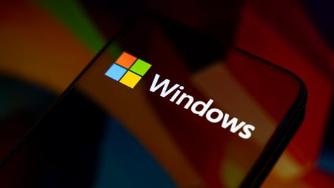 The Windows logo appears on the screen of a smartphone