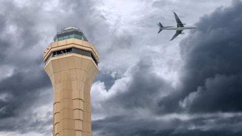 FAA air control tower and plae in background
