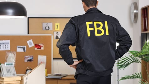 Male FBI agent in office, back view