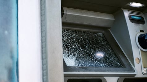 Broken glass ATM on street