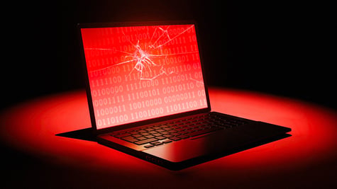 laptop with a broken glass, red, black background