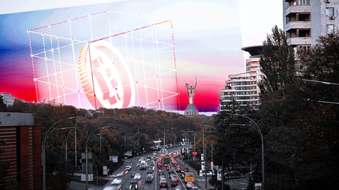 Crypto symbols and the panorama of Kyiv in the background