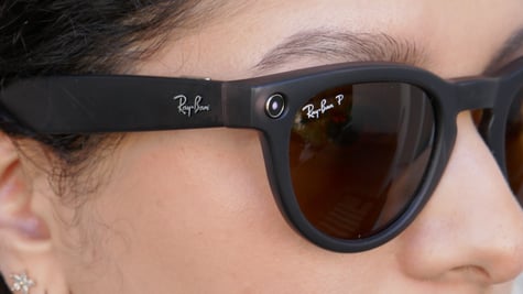 A woman is wearing a pair of Ray-Ban smart glasses.