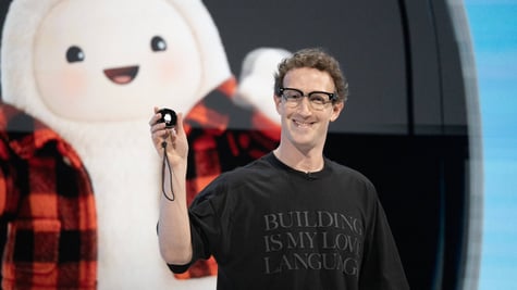 Meta CEO Mark Zuckerberg holding a Muse Charm device