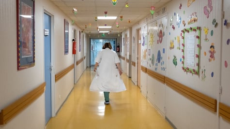 Nurse walking down a hospital corridor