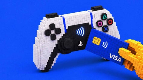 A hand making a card payment via PlayStation controller