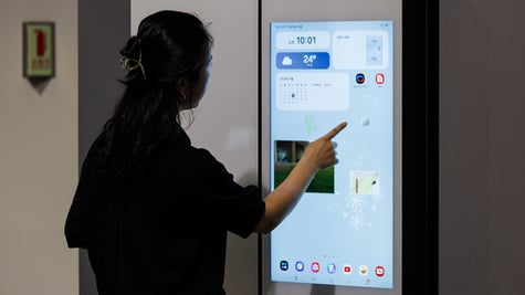 Woman using Samsung smart fridge