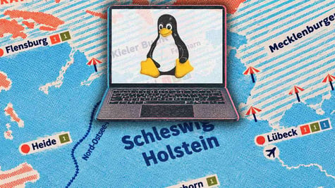 A laptop with Linux logo, a map of Schleswig-Holstein