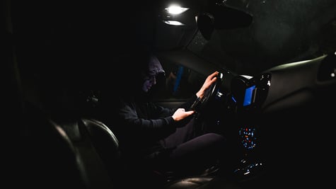 stalker in a car using smartphone
