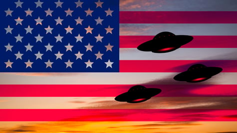 UFOs hovering around the US flag.