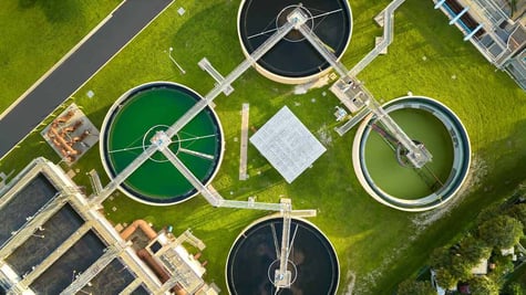 Water utility plants pictured from above, surrounded by greengrass