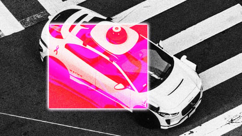 A Waymo autonomous robotaxi in a street.