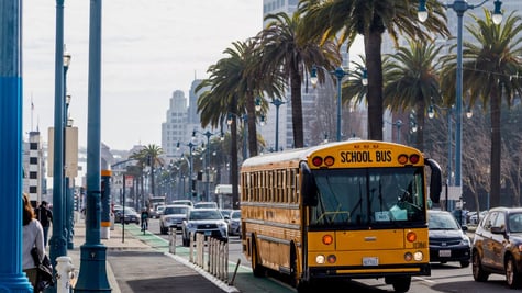 San Diego school bus on city streets with palm trees