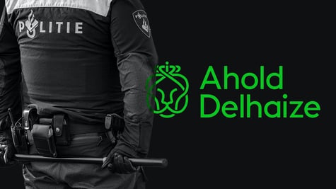 Ahold Delhaize and Dutch police officer holding a baton behind his back