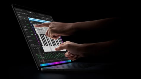 Hand using Apple MacBook Pro touchscreen