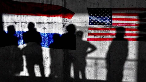 Graffitis of the Dutch and the US flags, shadows of people