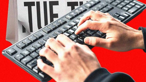 Hands over a keybord, calendar sheet showing Tuesday.
