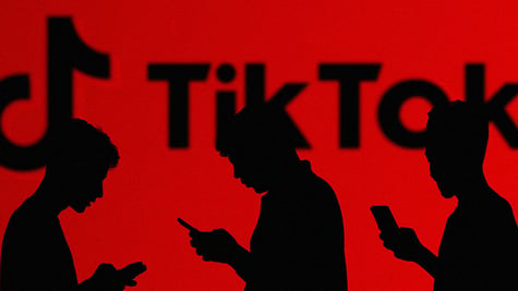 People in red background with TikTok logo