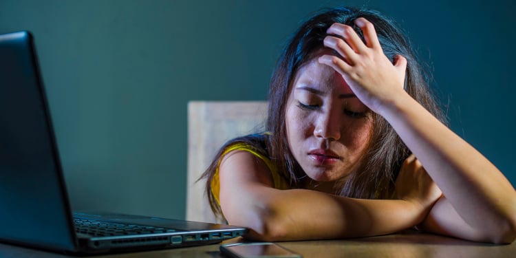 upset teenager by the laptop