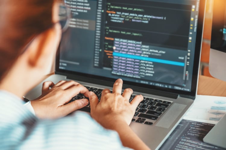 woman by computer coding