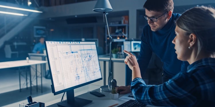 Man and a woman in front of a computer