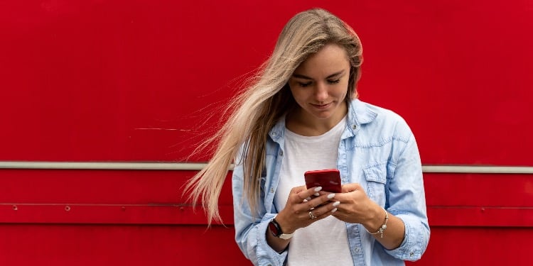 woman blond with a phone smiling