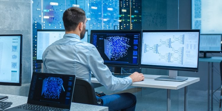 Man in front of multiple computers