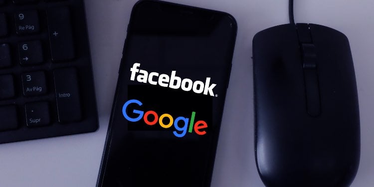 Facebook and Google on mobile screen near mouse