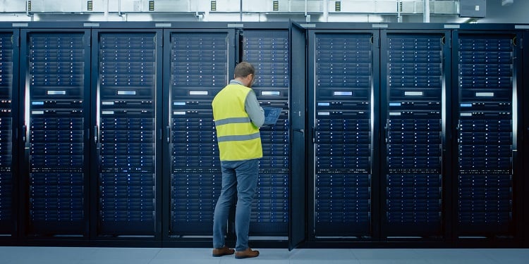 Man standing near cable cabinet