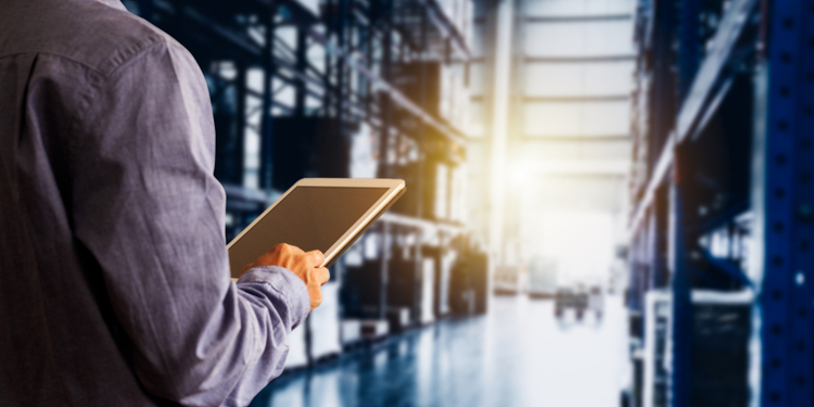 Businessman manager using tablet check and control for workers with Modern Trade warehouse
