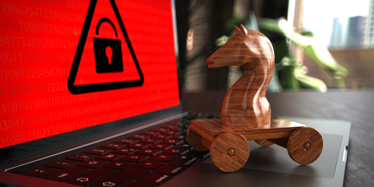 Wooden trojan horse on a laptop with red warning screen