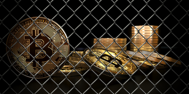 Bitcoin behind fence. Crypto ban concept