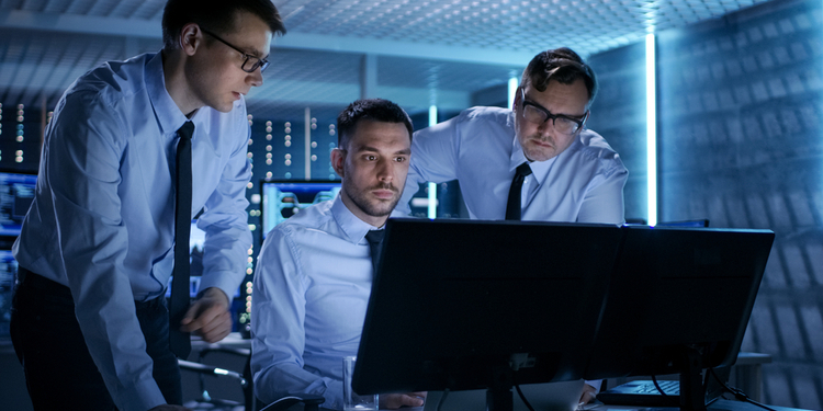 Three Operations Engineers Solving Problem in a Monitoring Room