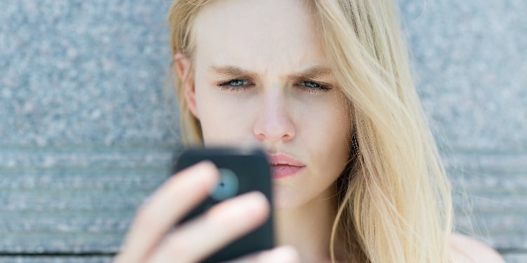 blond woman holding a smartphone