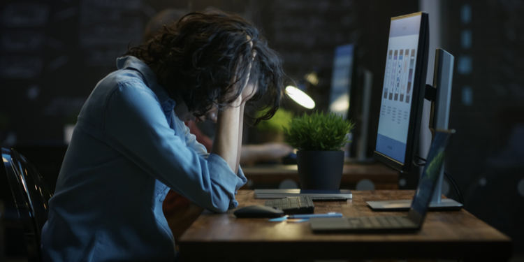 Tired woman sitting in front of PC