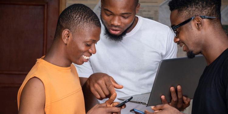 Three young african people using their mobile phones and laptops
